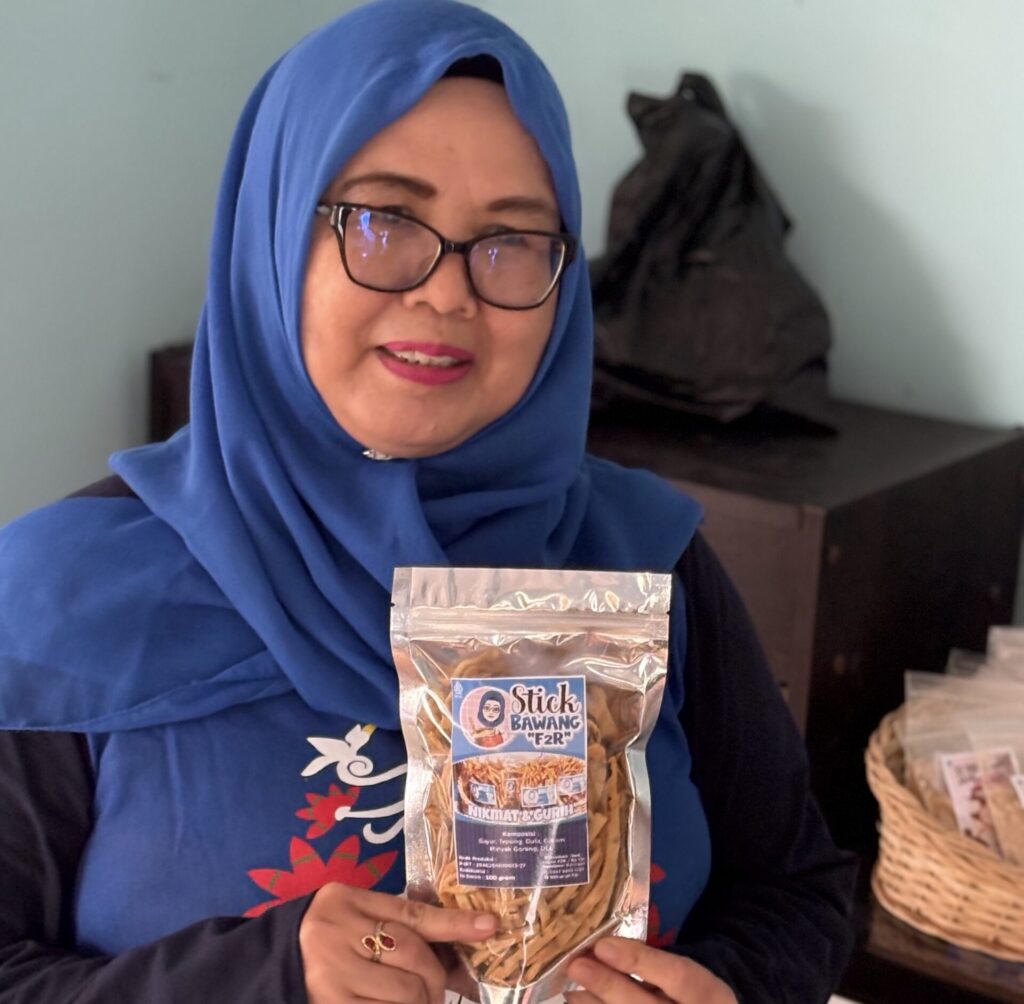 KMP Microfinance with lady holding product